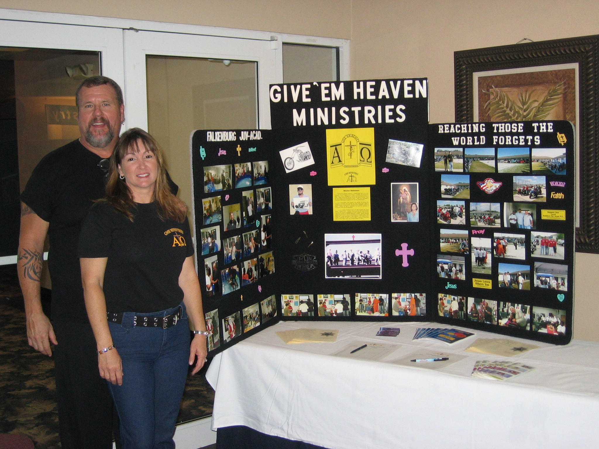 Joe and Robin Pottle with the Give 'Em Heaven Ministries display board